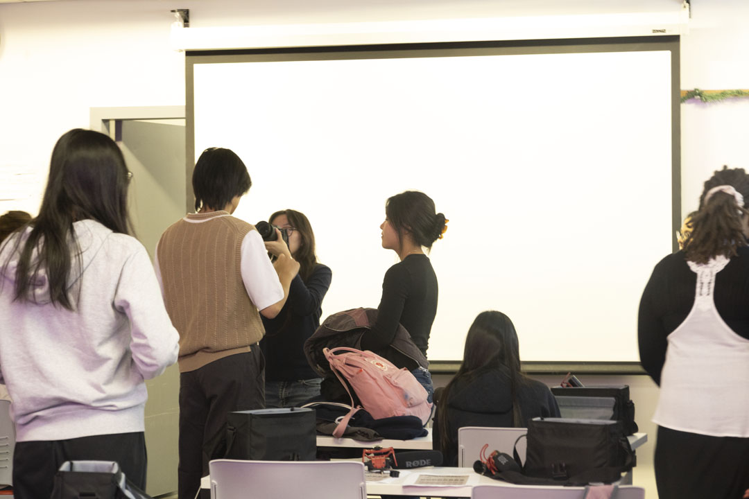 Students in the NMA Studio playing with cameras.