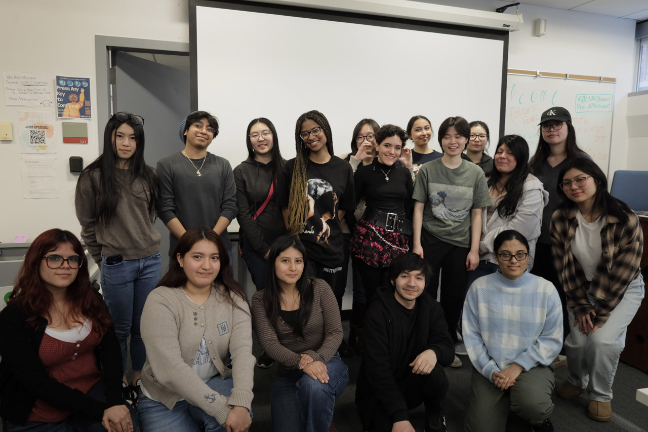 Seventeen students pose for a group photo in the NMA Studio.