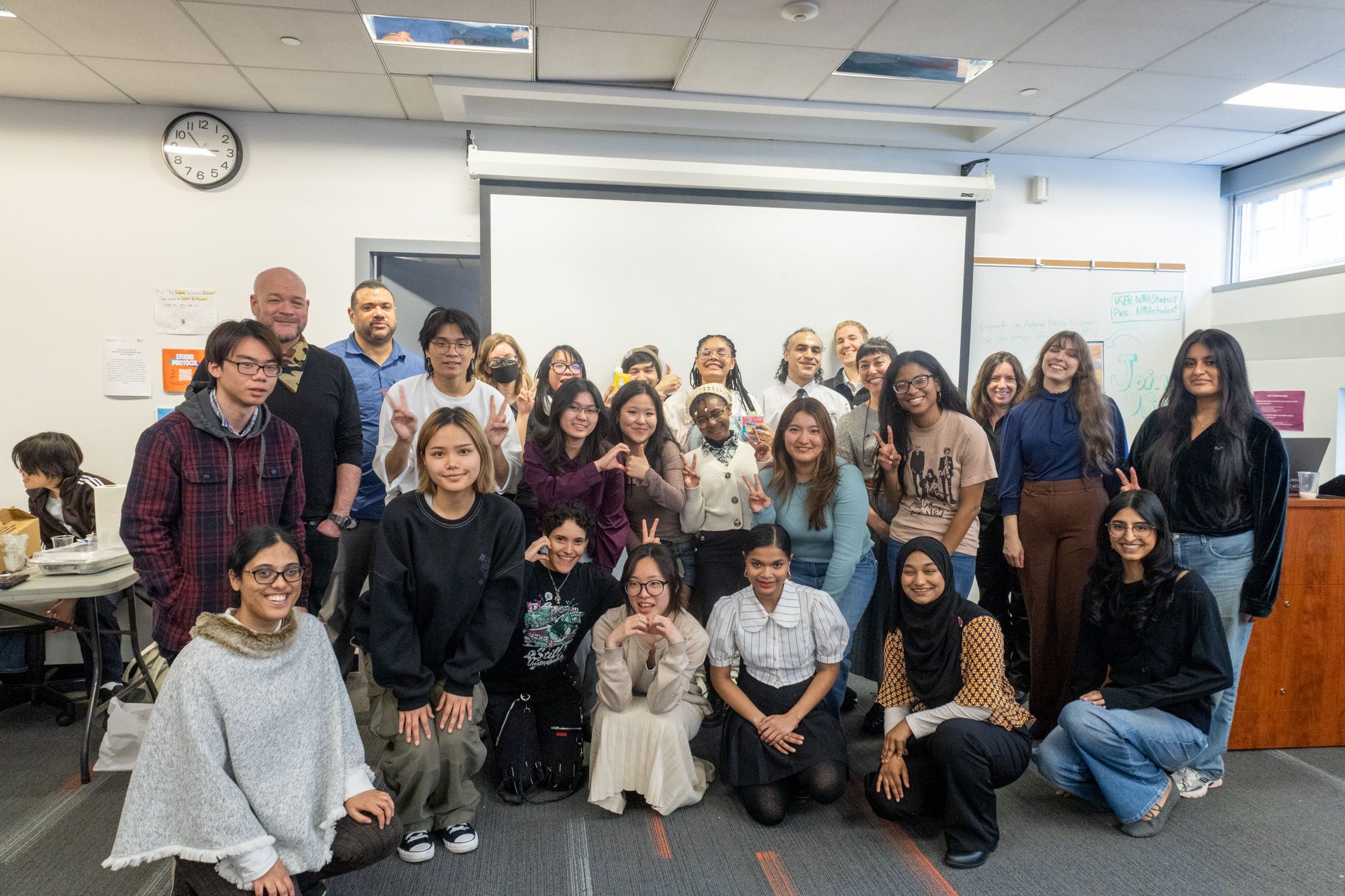 Students and faculty posing for a group photo in front of the NMA Studio